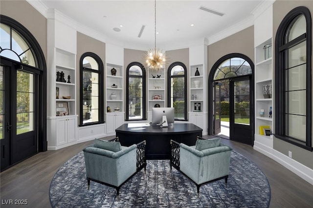 interior space featuring dark wood-type flooring, a notable chandelier, visible vents, and ornamental molding