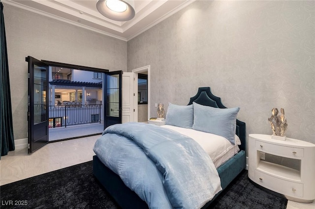 bedroom featuring a tray ceiling, access to outside, and ornamental molding