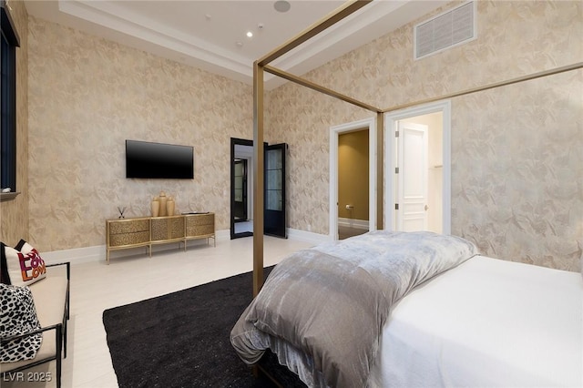 bedroom with wallpapered walls, baseboards, and visible vents