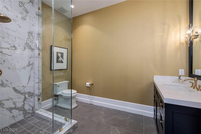 bathroom with vanity, toilet, an enclosed shower, and baseboards