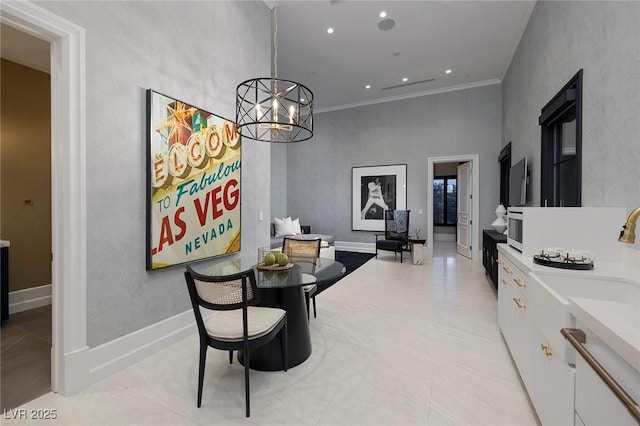 dining area featuring a chandelier, recessed lighting, baseboards, and ornamental molding