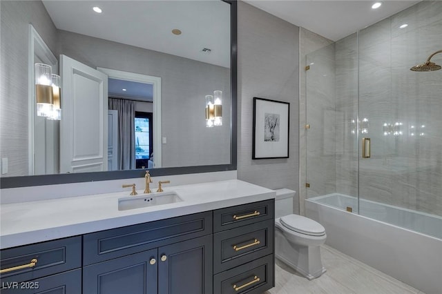 bathroom with visible vents, toilet, vanity, and bath / shower combo with glass door