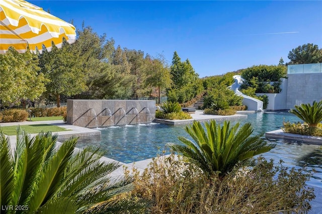 outdoor pool featuring a water slide