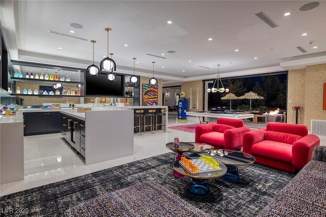 living room featuring visible vents, recessed lighting, wet bar, and marble finish floor