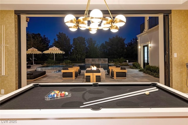 playroom with pool table and an inviting chandelier