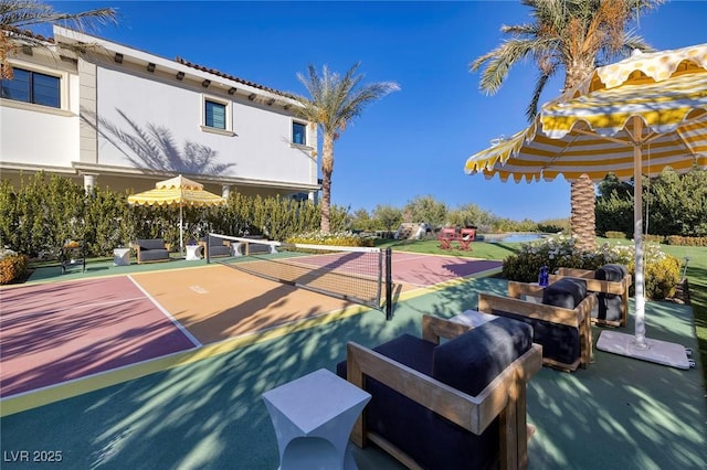 view of sport court featuring an outdoor living space