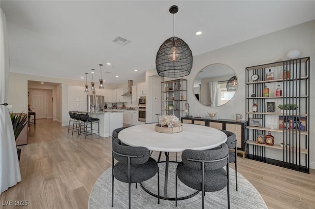 dining area featuring light wood-type flooring