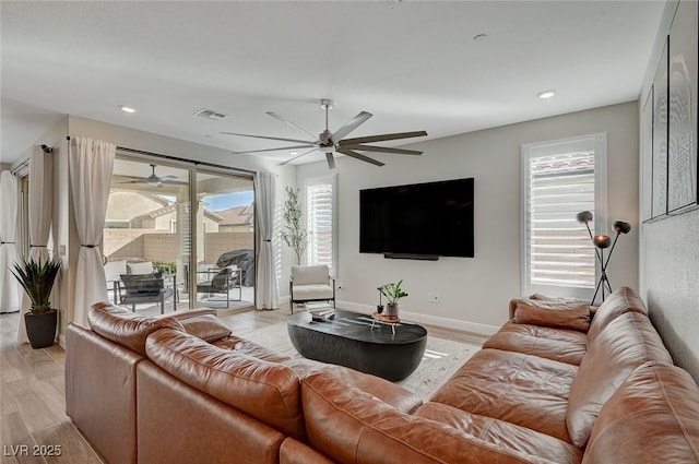 living room with ceiling fan and light wood-type flooring