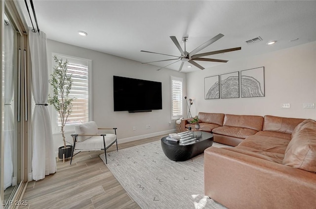 living room featuring ceiling fan and light wood-type flooring