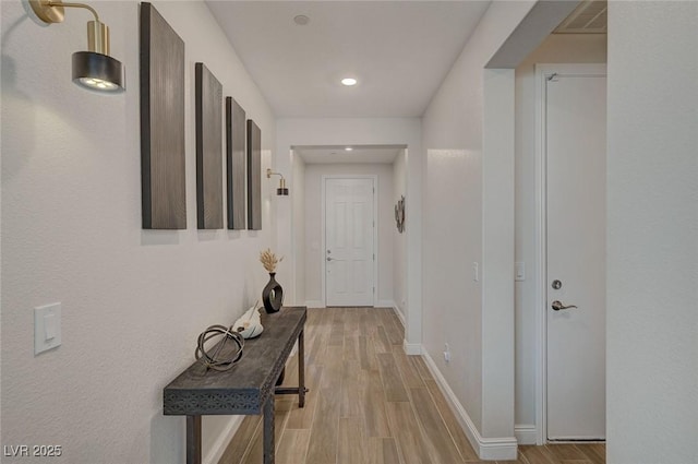 corridor with light hardwood / wood-style flooring