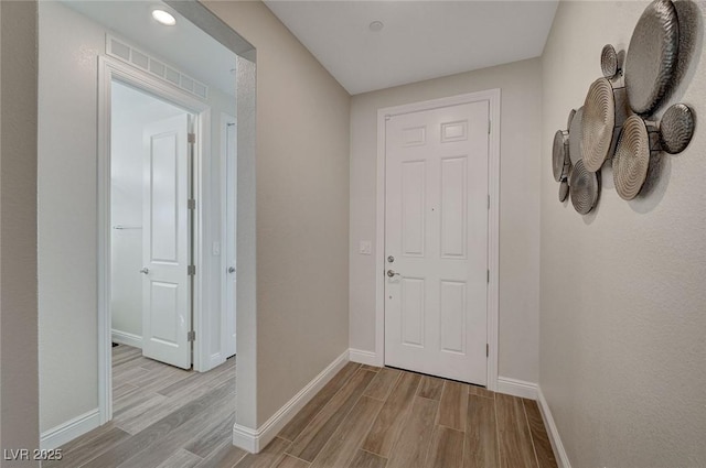 hall with light hardwood / wood-style floors