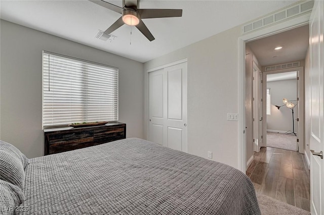 bedroom featuring ceiling fan, wood-type flooring, and a closet