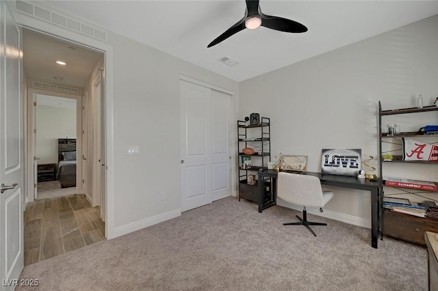 office area featuring light colored carpet and ceiling fan