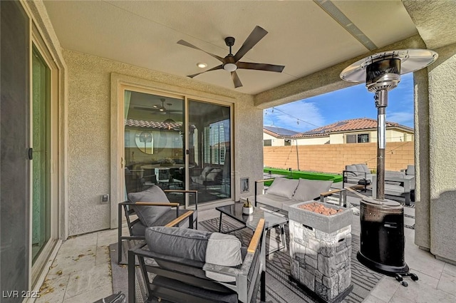 view of patio featuring ceiling fan and an outdoor fire pit