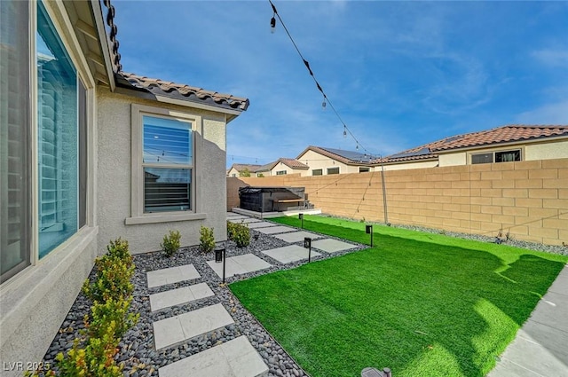 view of yard with a hot tub and a patio