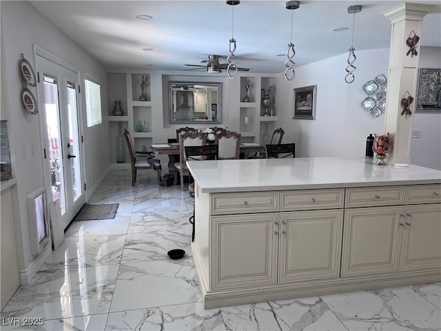 kitchen featuring cream cabinets, decorative light fixtures, and ceiling fan