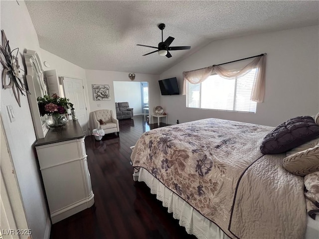 bedroom with ceiling fan, lofted ceiling, a textured ceiling, and dark hardwood / wood-style flooring