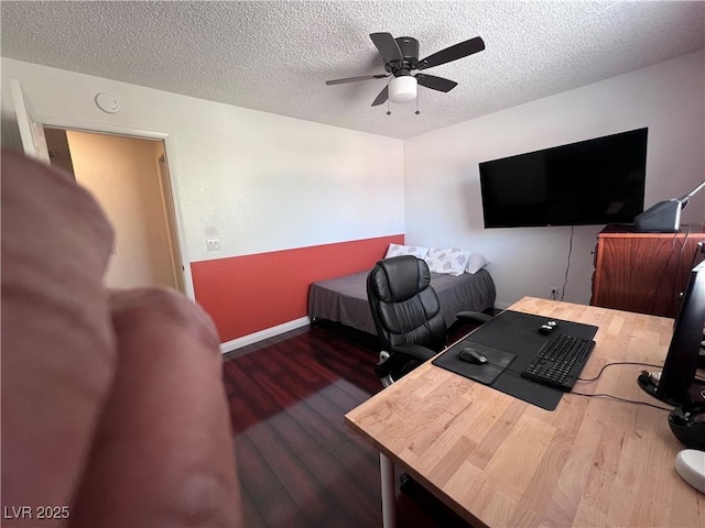 office area featuring dark hardwood / wood-style flooring, a textured ceiling, and ceiling fan