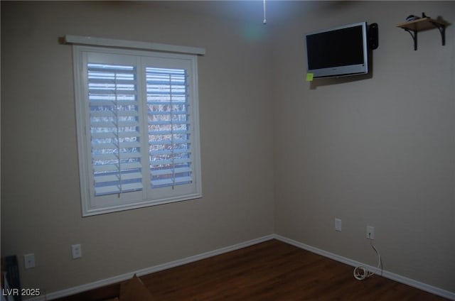 unfurnished room with dark hardwood / wood-style flooring