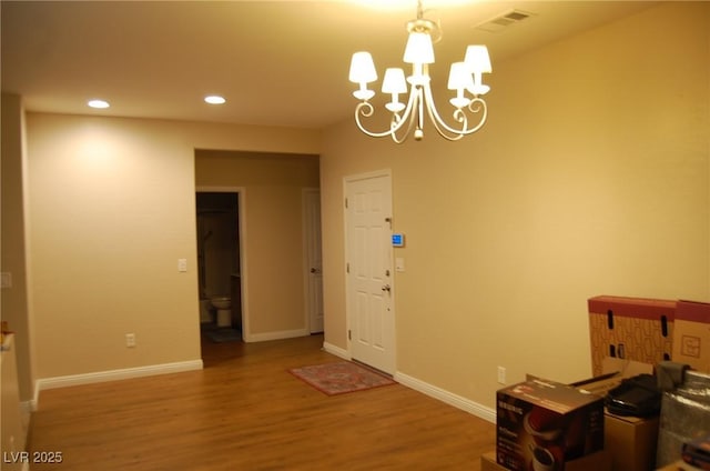 interior space with hardwood / wood-style flooring and a chandelier