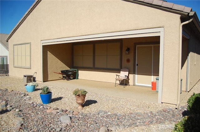 back of property with a patio