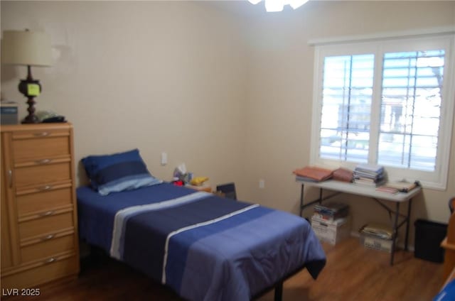 bedroom with dark hardwood / wood-style flooring