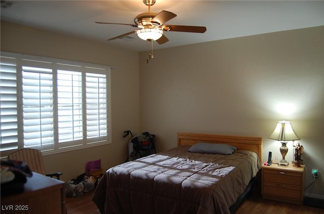 bedroom with ceiling fan and wood-type flooring