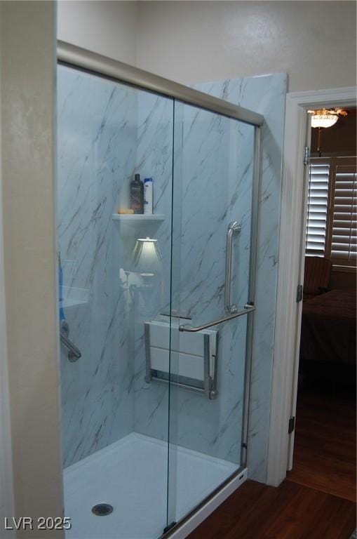 bathroom featuring an enclosed shower and hardwood / wood-style floors