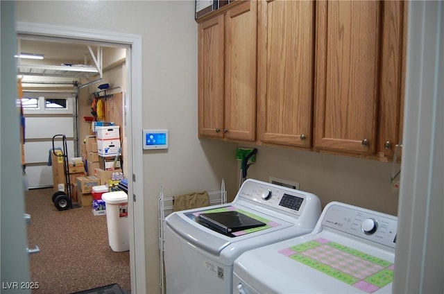 clothes washing area with cabinets and washer and dryer