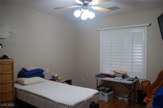 bedroom with dark wood-type flooring and ceiling fan