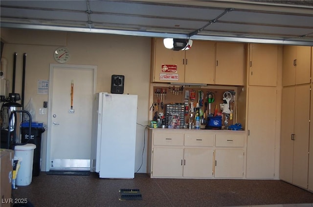 garage with white refrigerator and a garage door opener