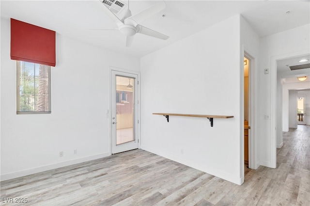 spare room with light hardwood / wood-style floors and ceiling fan