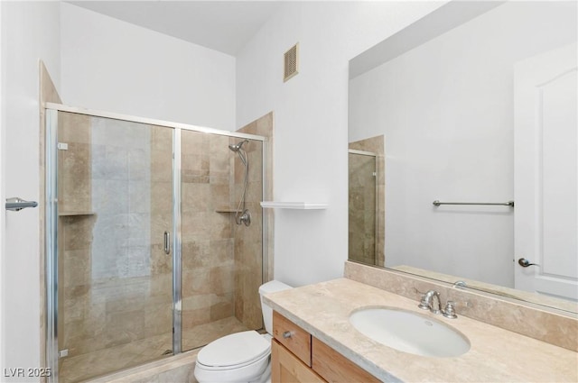 bathroom with vanity, toilet, and an enclosed shower