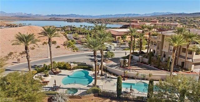 birds eye view of property featuring a water and mountain view