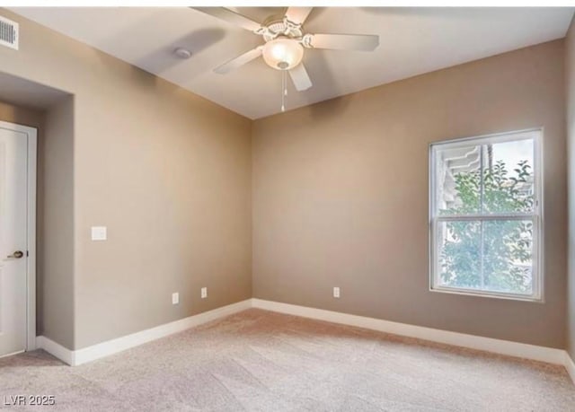 spare room featuring ceiling fan and light carpet