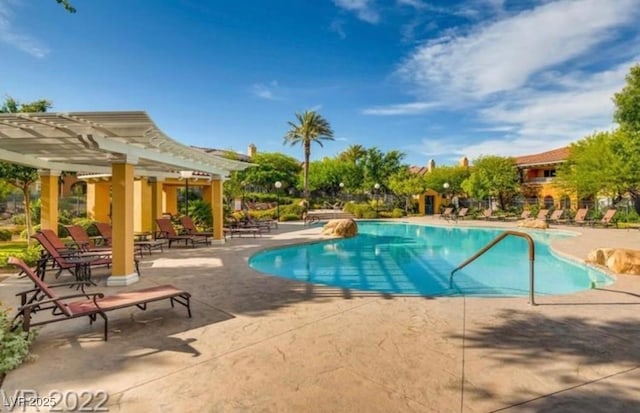 view of swimming pool featuring a pergola and a patio