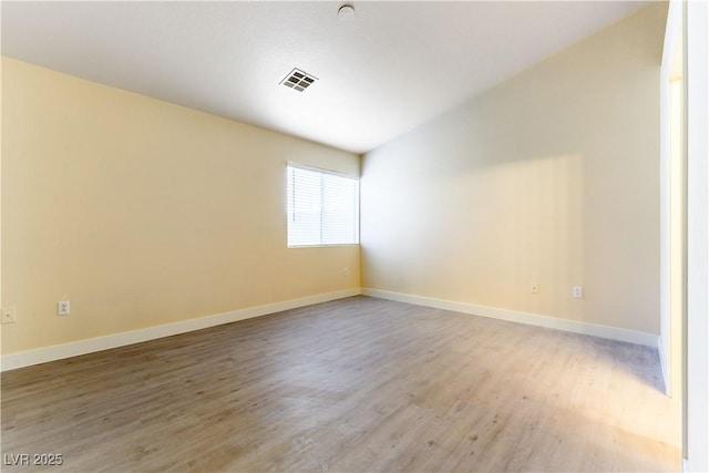 empty room with hardwood / wood-style floors