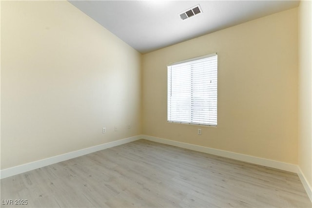 spare room with light hardwood / wood-style floors