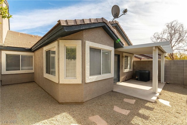 view of home's exterior with central AC and a patio