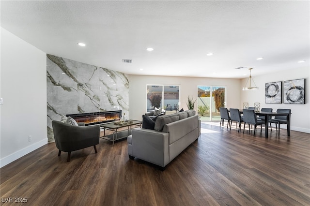 living room featuring dark hardwood / wood-style floors and a premium fireplace