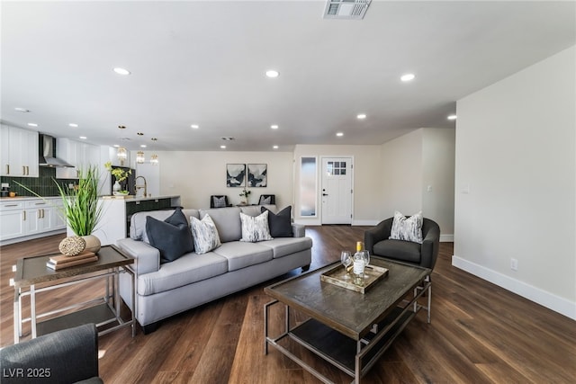 living room with sink and dark hardwood / wood-style flooring