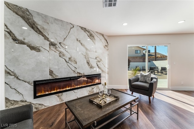 living room with hardwood / wood-style flooring and a fireplace