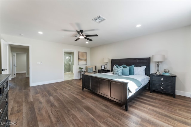 bedroom with dark hardwood / wood-style floors, ceiling fan, and ensuite bath