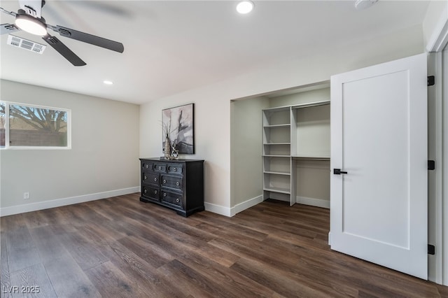 unfurnished bedroom with ceiling fan and dark hardwood / wood-style floors