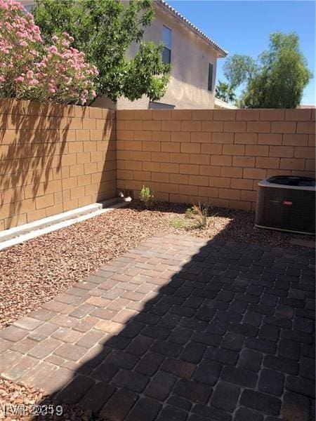 view of patio featuring fence and central AC unit