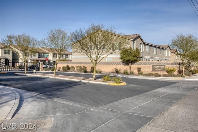 view of building exterior featuring a residential view and fence