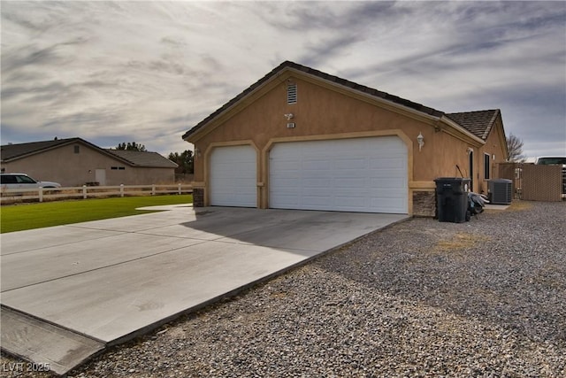 view of property exterior featuring an outbuilding, a garage, and central AC