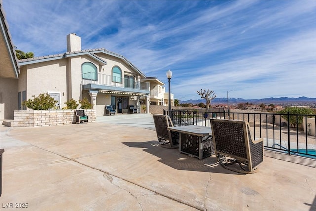 view of patio / terrace featuring a mountain view and a balcony