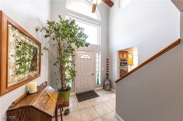 tiled foyer entrance with a high ceiling