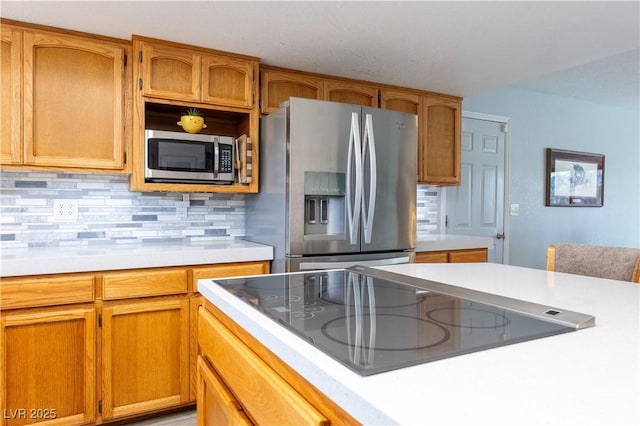 kitchen with stainless steel appliances and backsplash